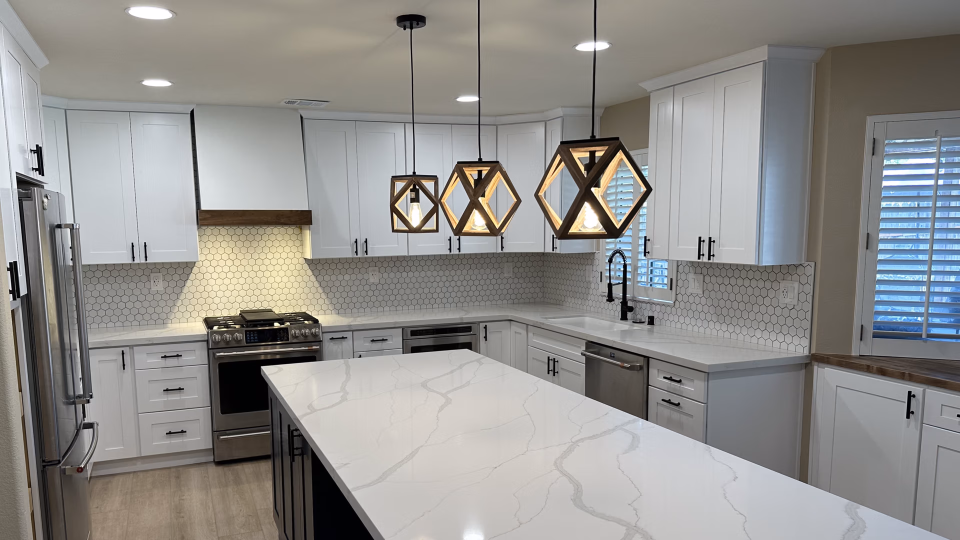 marble counter tops, white cabinetry, after remodel